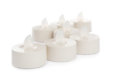 Photo of Decorative flameless LED candles on white background