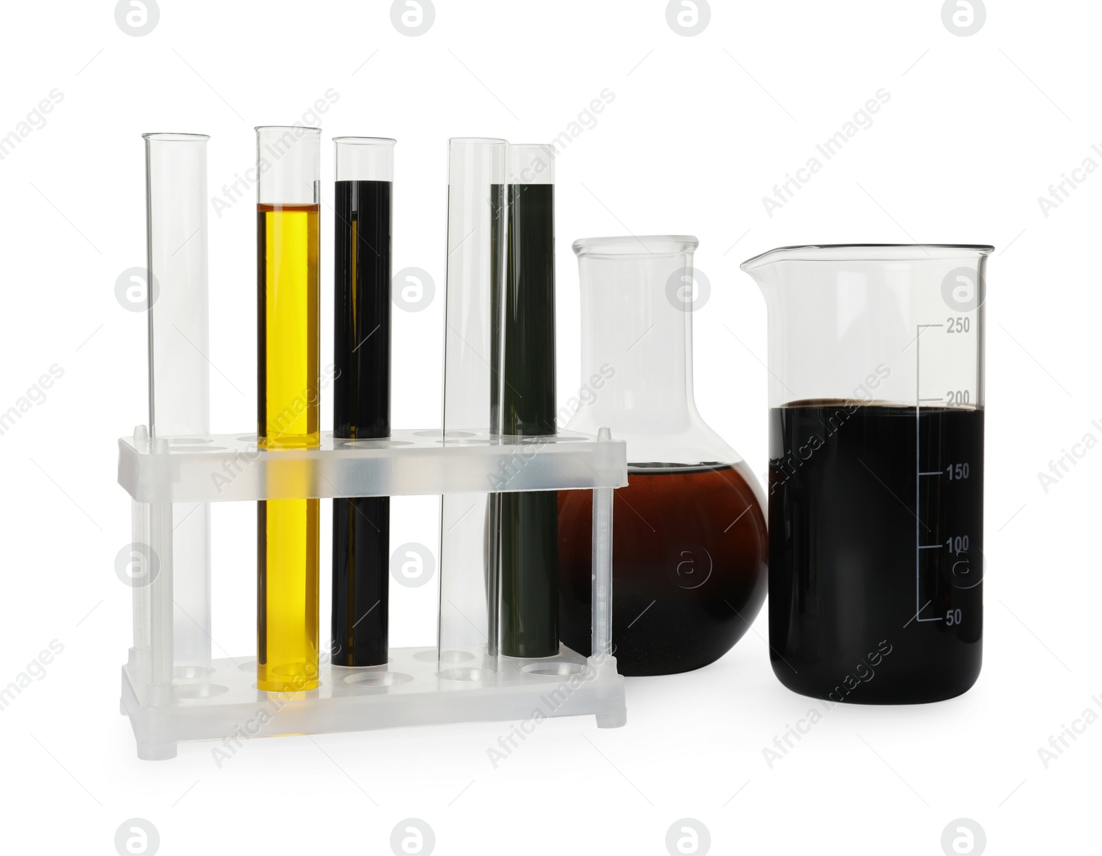 Photo of Laboratory glassware with different types of crude oil isolated on white