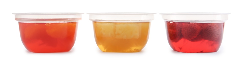 Photo of Tasty jelly desserts in plastic cups on white background