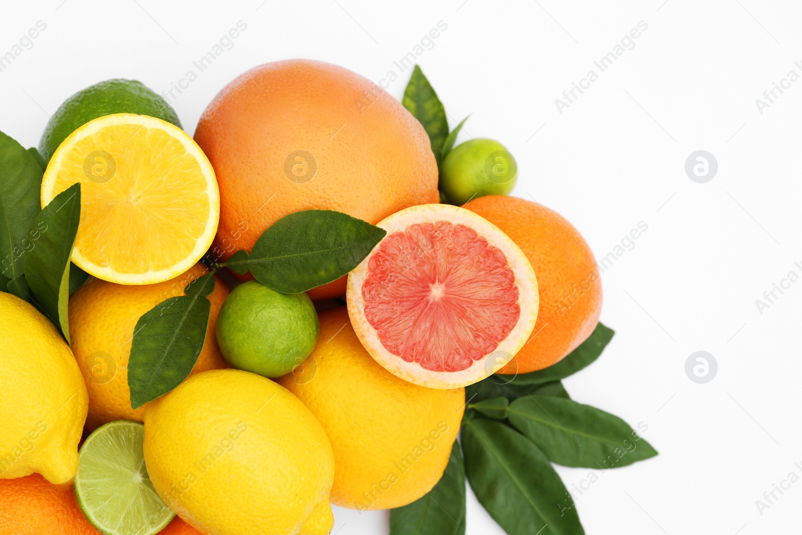 Photo of Different citrus fruits and leaves on white background, top view