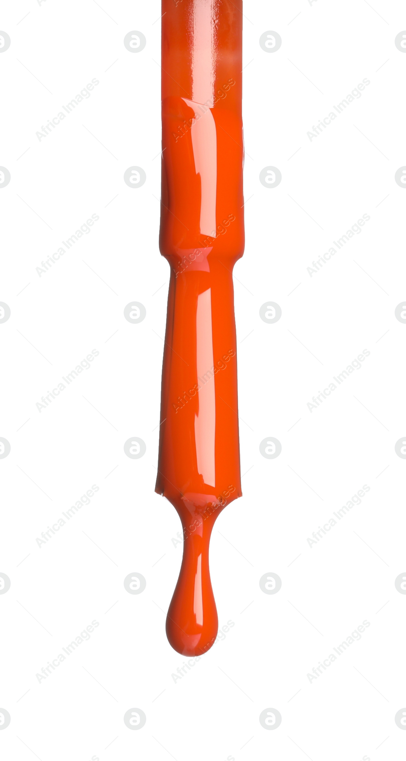 Photo of Orange nail polish dripping from brush isolated on white