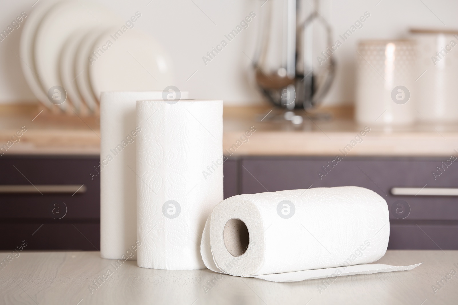 Photo of Rolls of paper towels on table in kitchen