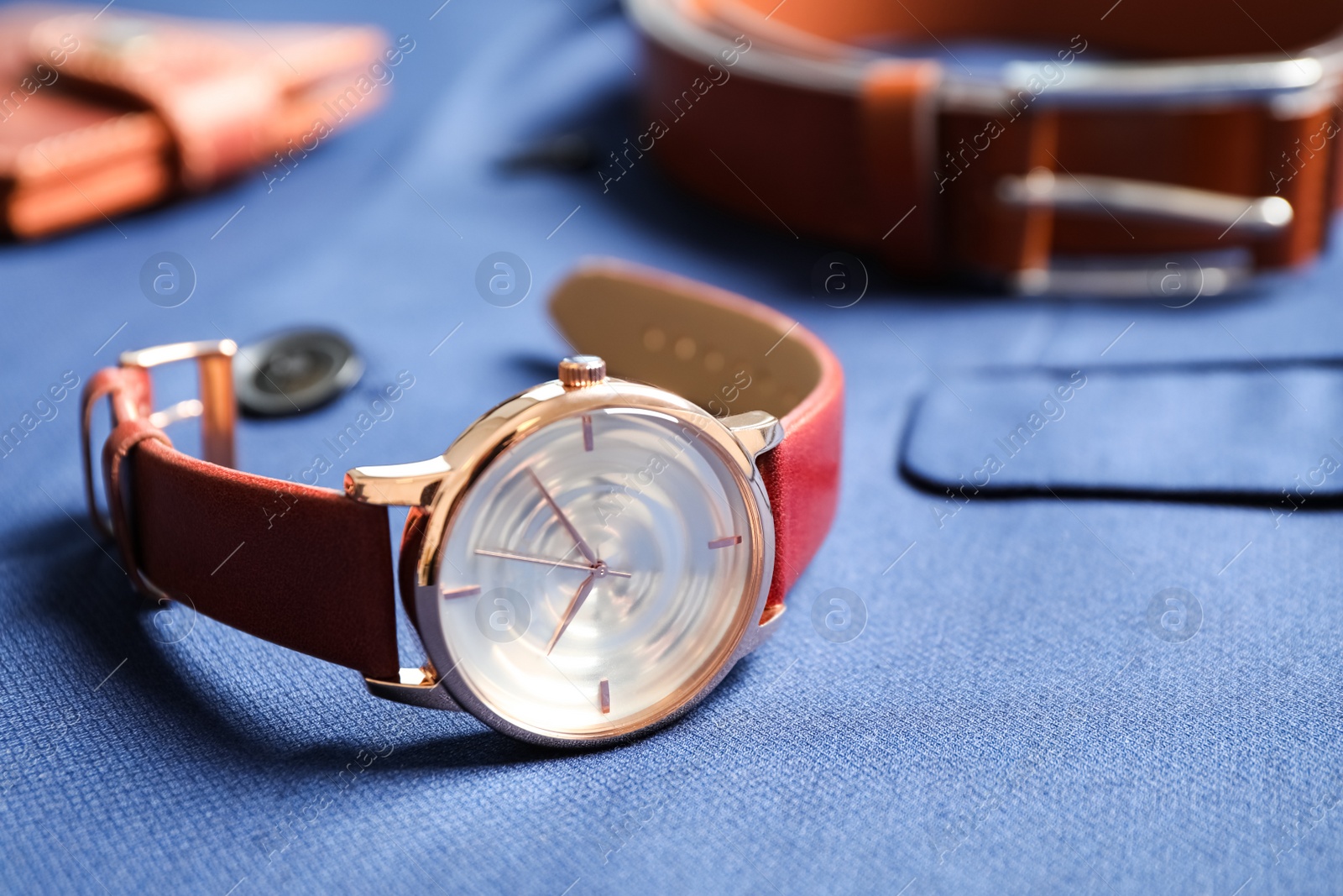 Photo of Luxury wrist watch on blue shirt, closeup