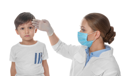 Photo of Doctor examining little boy with chickenpox on white background. Varicella zoster virus