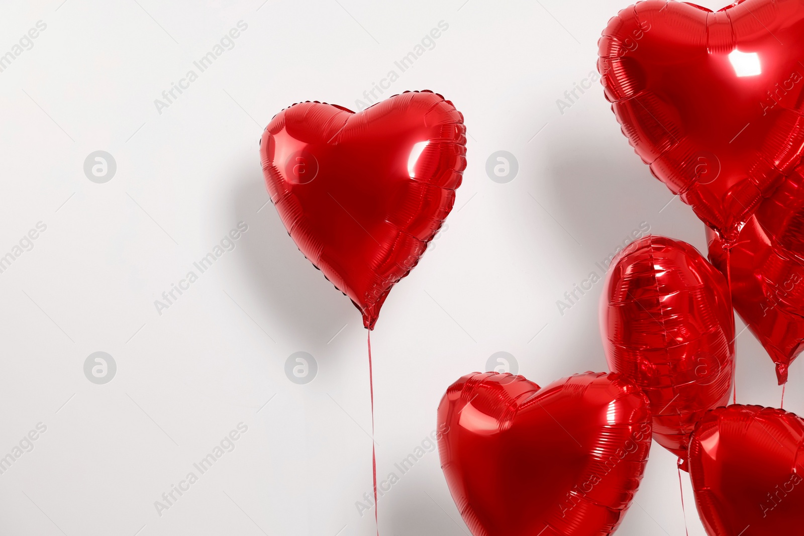 Photo of Many red heart shaped balloons on white background, space for text