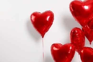 Many red heart shaped balloons on white background, space for text