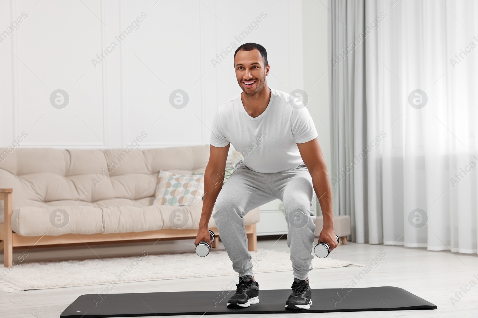 Photo of Man doing morning exercise on fitness mat at home