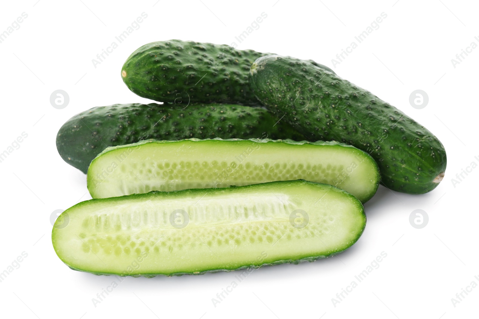 Photo of Whole and cut cucumbers on white background