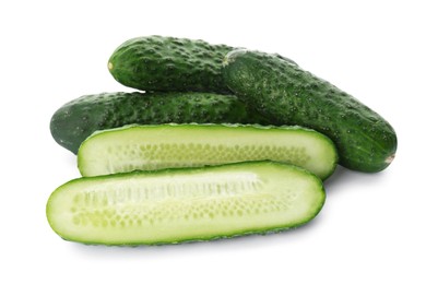 Photo of Whole and cut cucumbers on white background