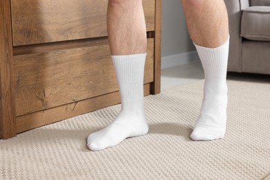 Photo of Man in stylish white socks indoors, closeup