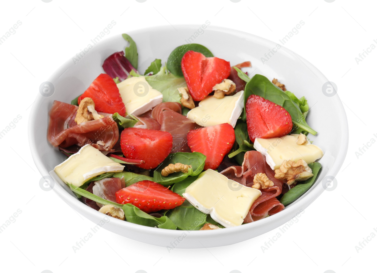 Photo of Tasty salad with brie cheese, prosciutto, strawberries and walnuts isolated on white