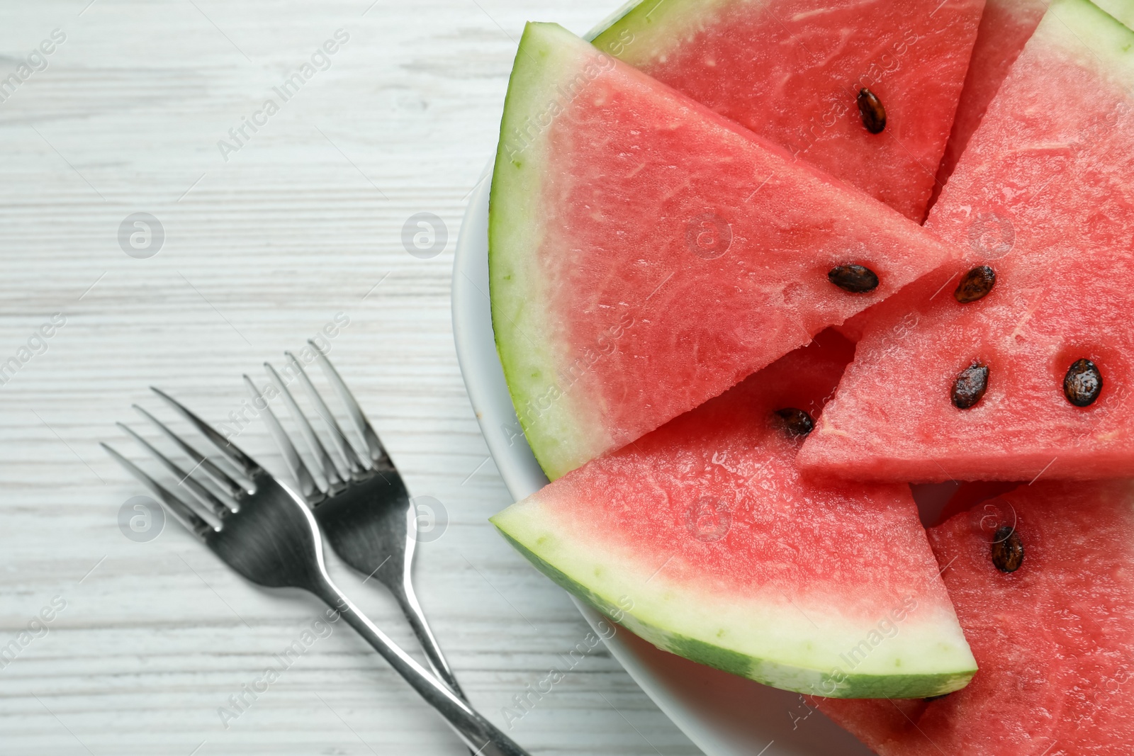 Photo of Delicious fresh watermelon slices on white wooden table, flat lay