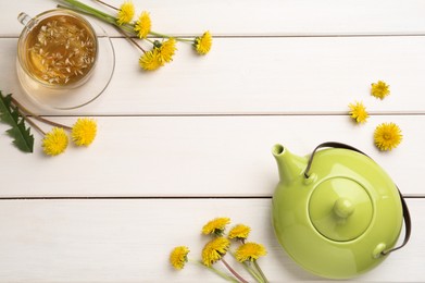 Photo of Delicious fresh tea and dandelion flowers on white wooden table, flat lay. Space for text