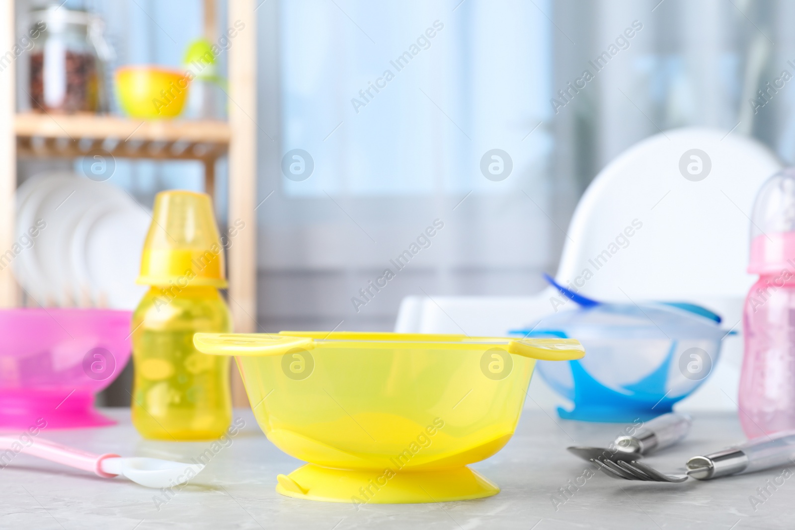 Photo of Bright child's dishware on grey table indoors