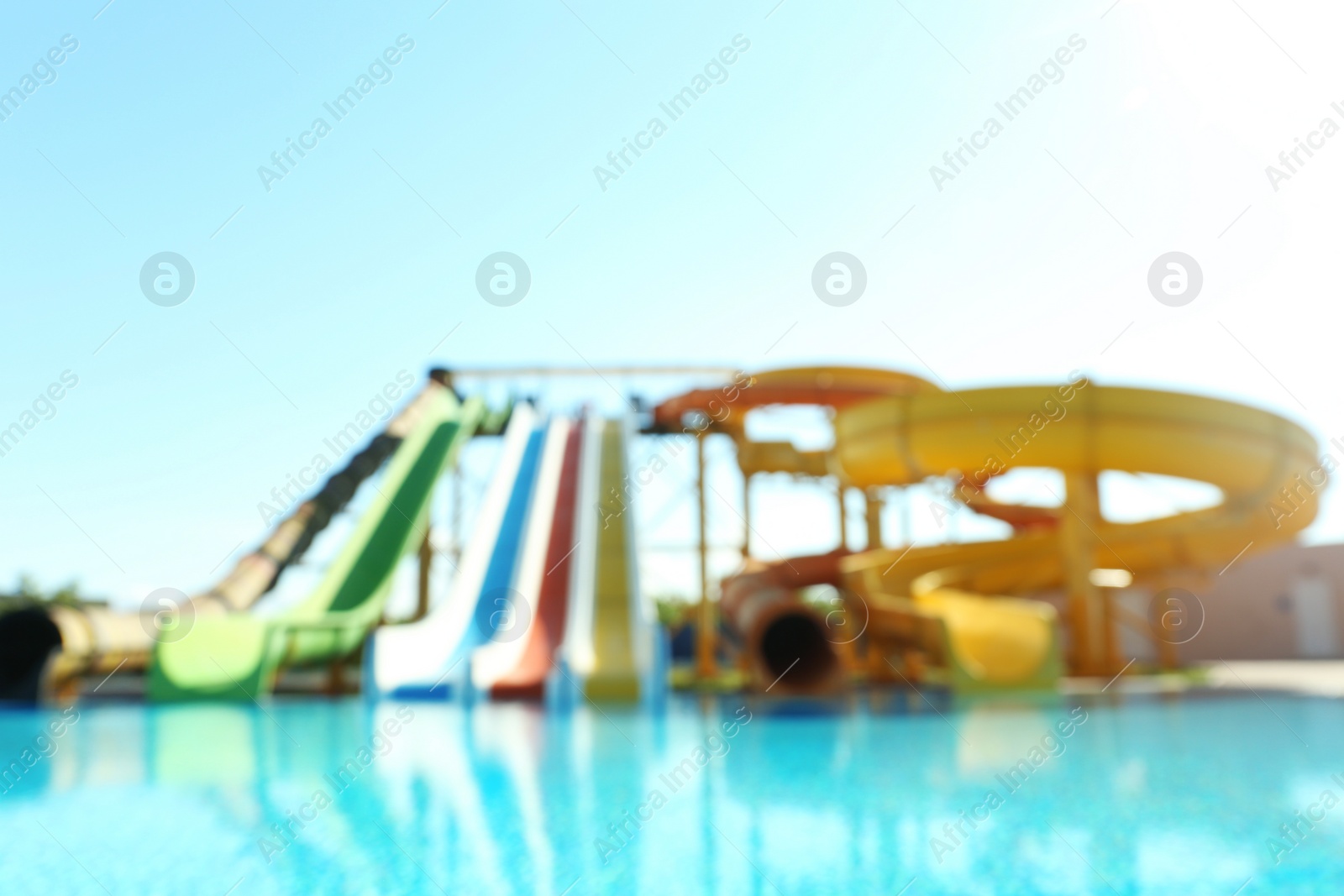 Photo of Different colorful slides in water park, blurred view