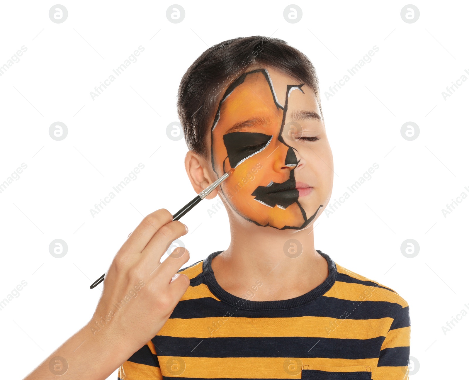 Photo of Artist painting face of little boy on white background