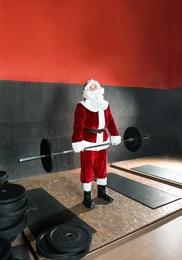 Photo of Young Santa Claus training in modern gym