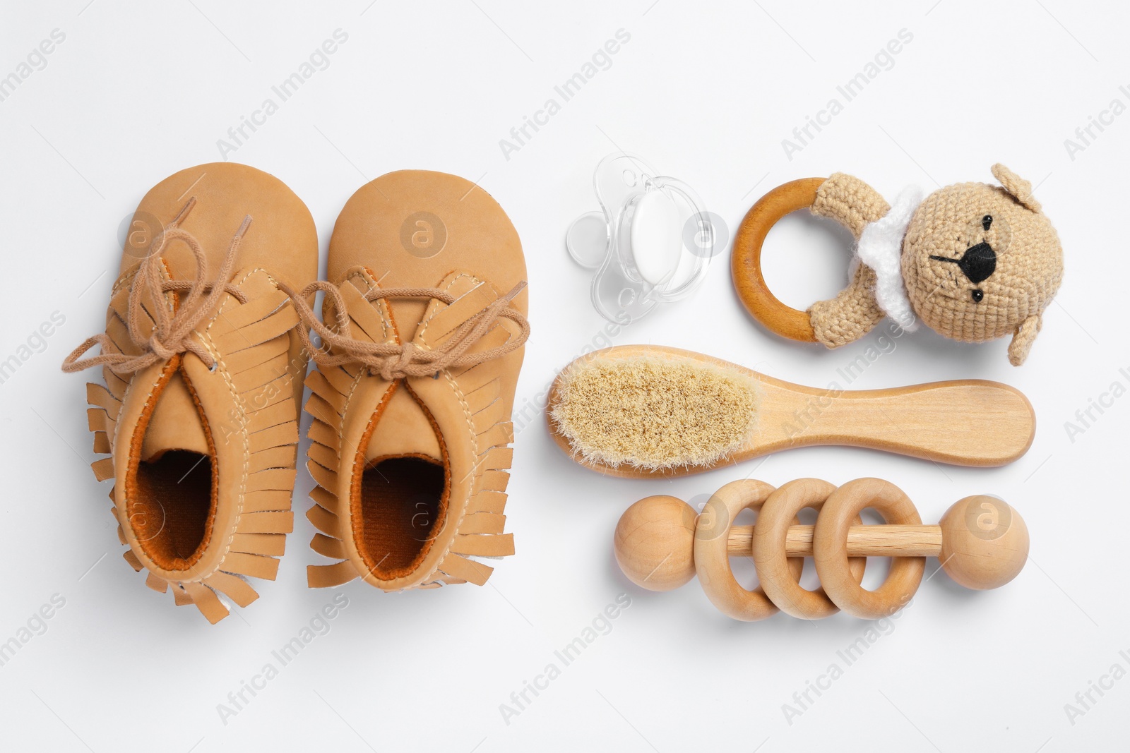 Photo of Flat lay composition with pacifier and other baby stuff on white background