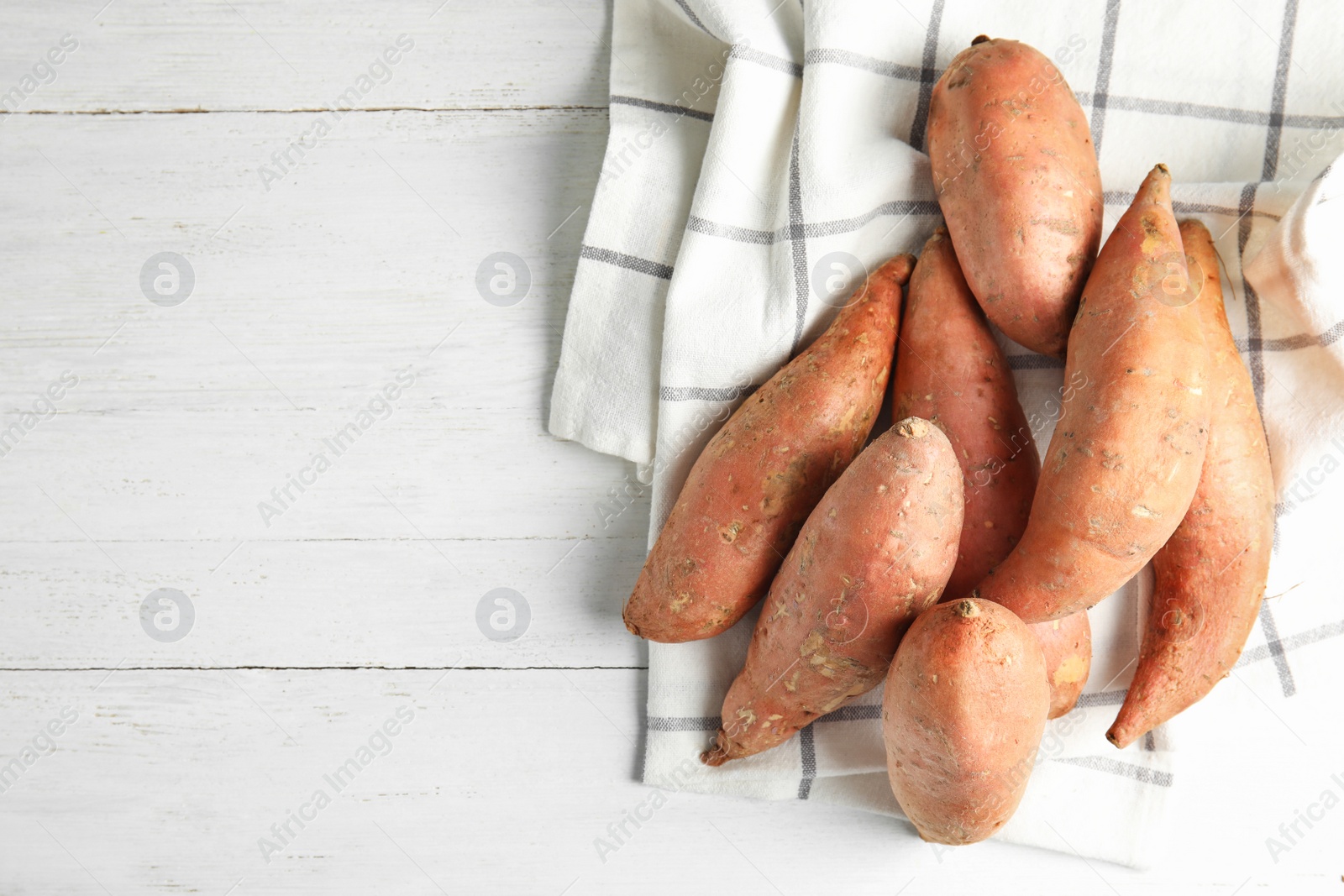 Photo of Flat lay composition with sweet potatoes and space for text on white wooden background