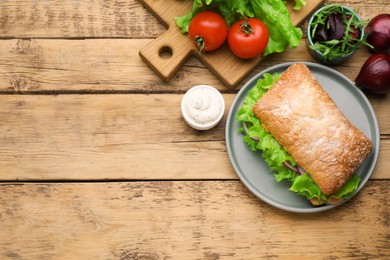 Photo of Delicious sandwich with fresh vegetables and salmon on wooden table, flat lay. Space for text