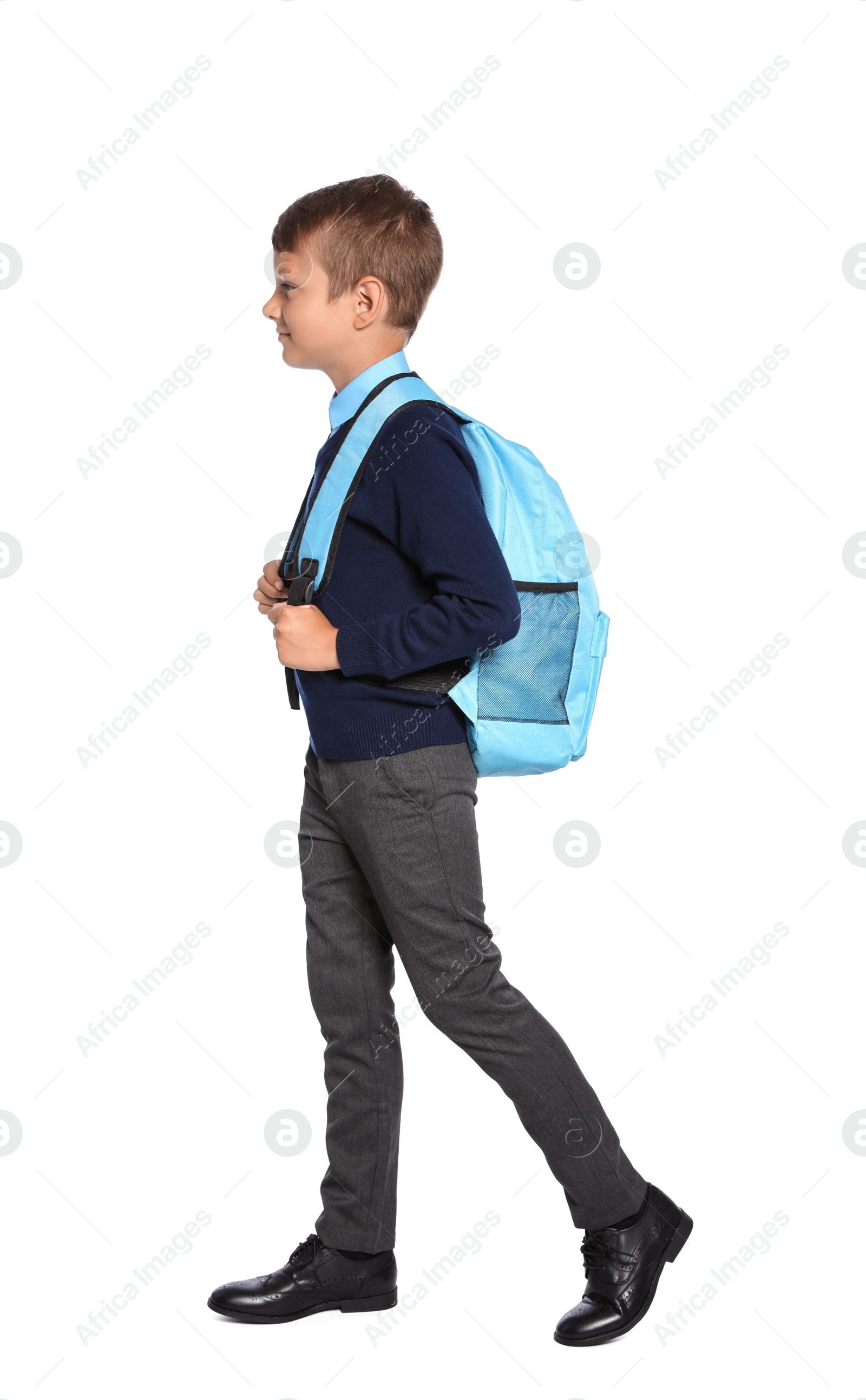 Photo of Little boy in stylish school uniform on white background