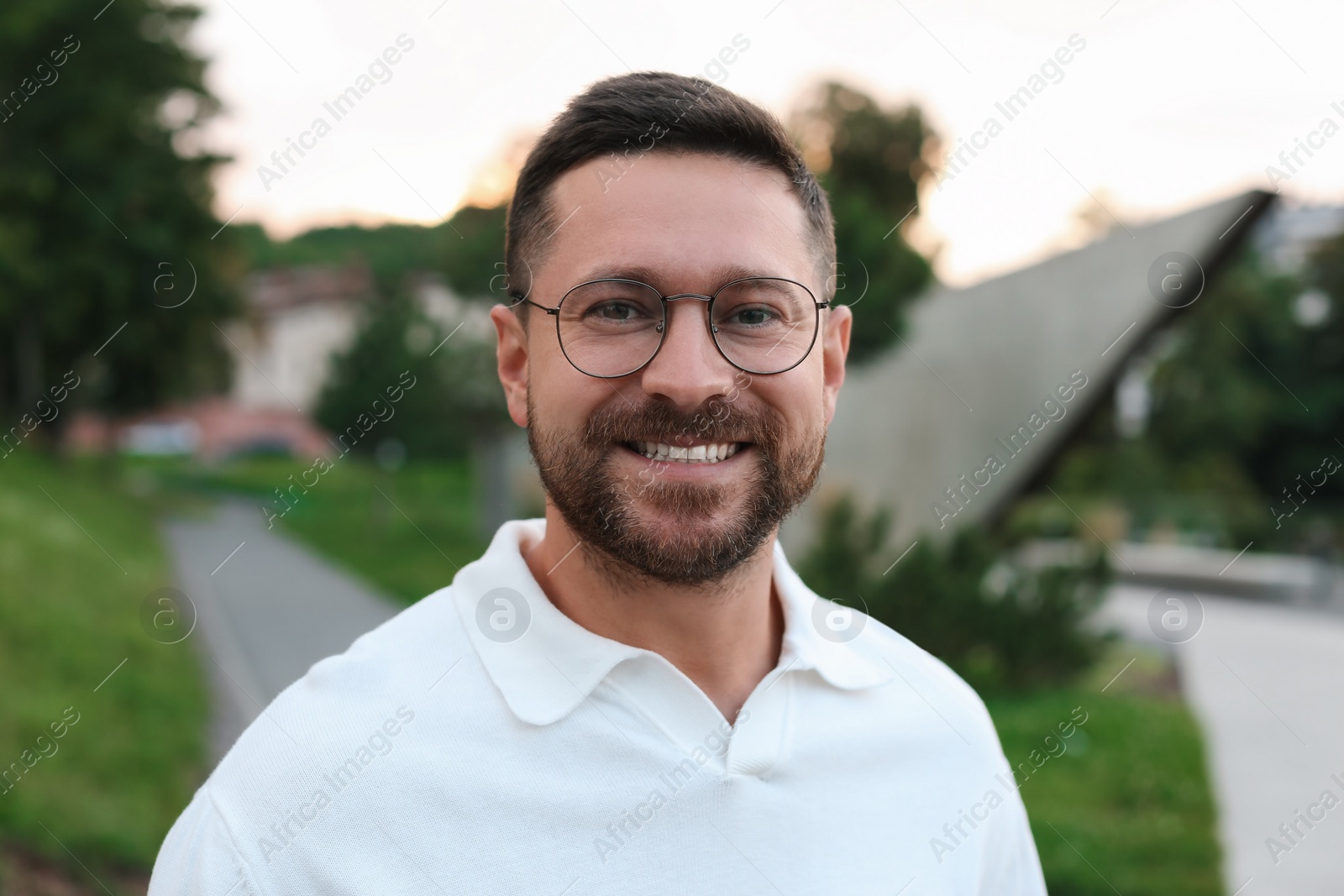 Photo of Portrait of handsome bearded man in glasses outdoors