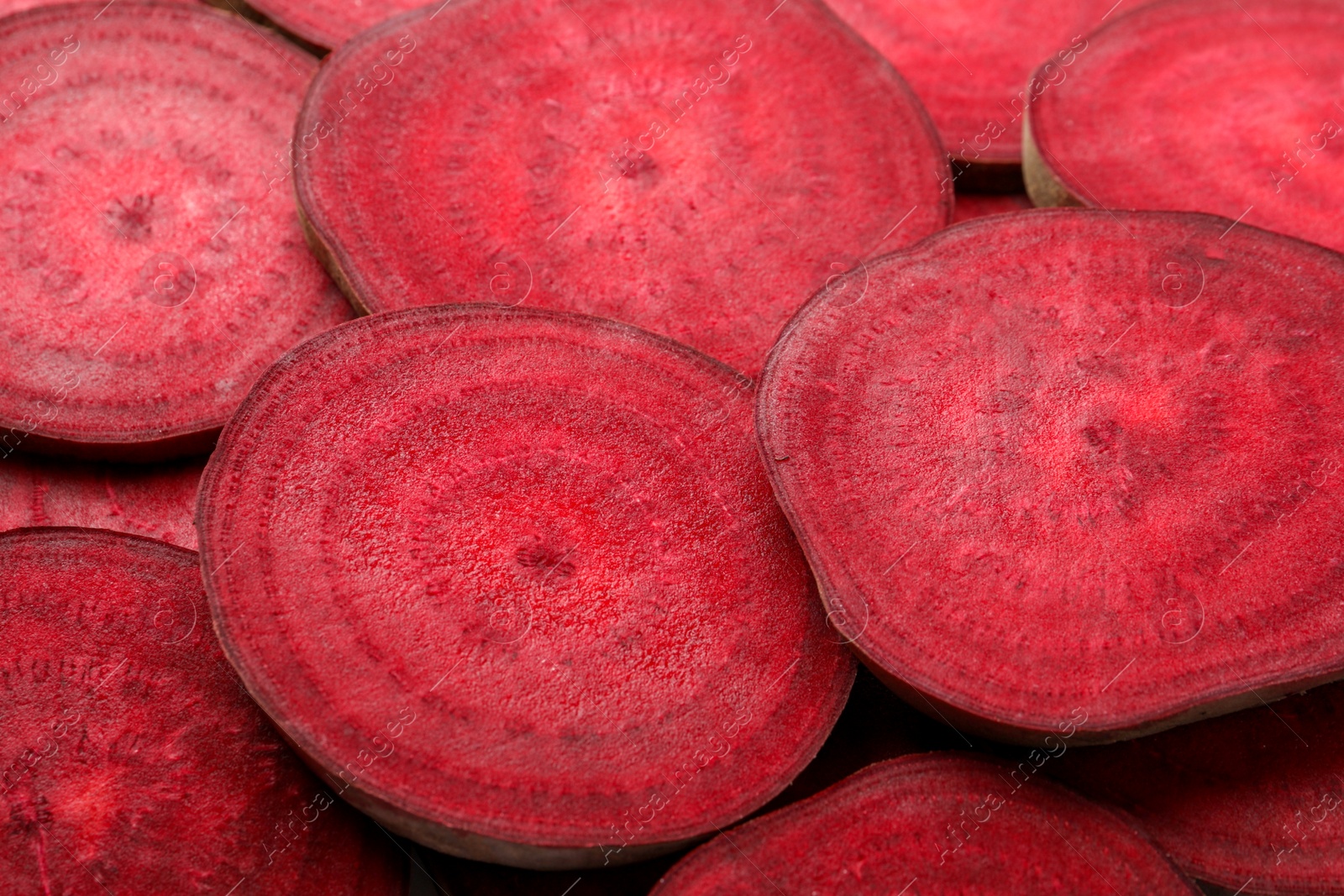 Photo of Slices of fresh beets as background, closeup