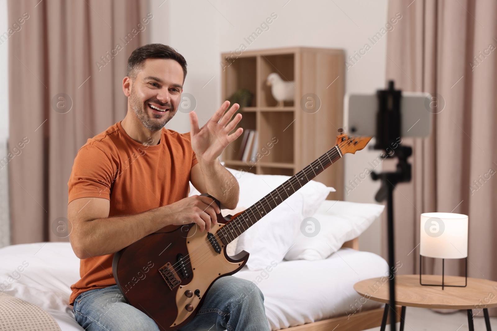 Photo of Music teacher talking with students while conducting online lesson at home. Time for hobby