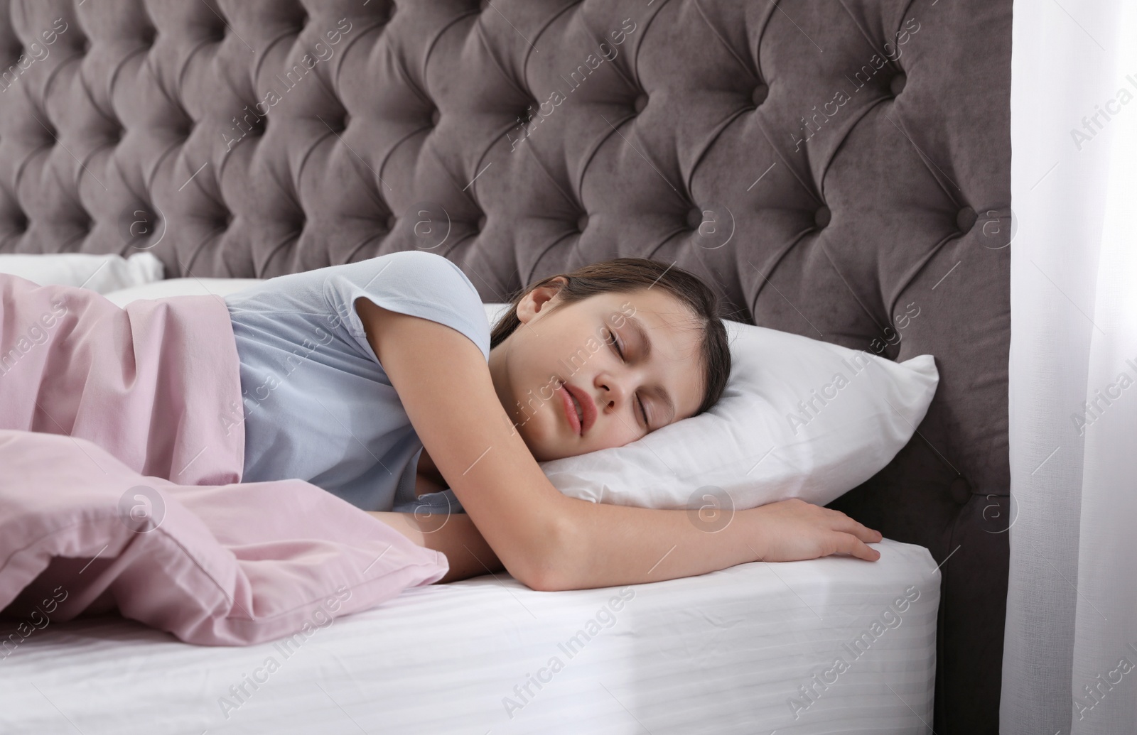 Photo of Beautiful little girl sleeping in bed at home