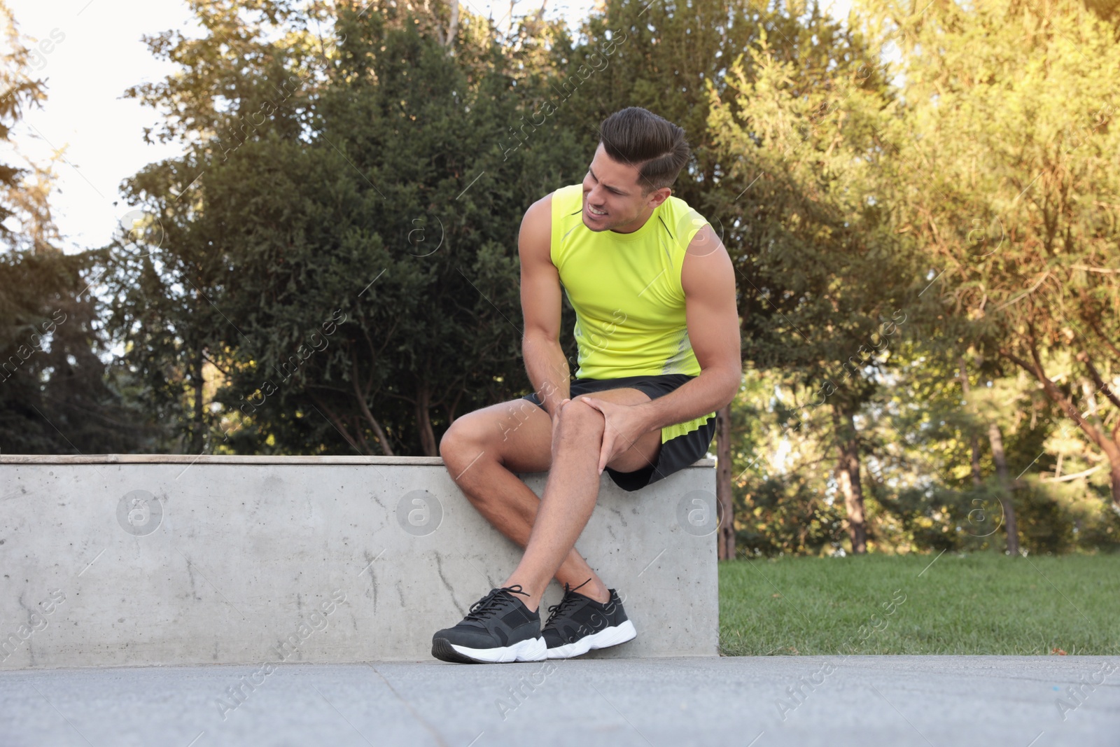 Photo of Man in sportswear having knee problems in park