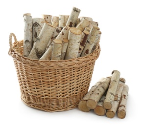 Wicker basket with firewood on white background