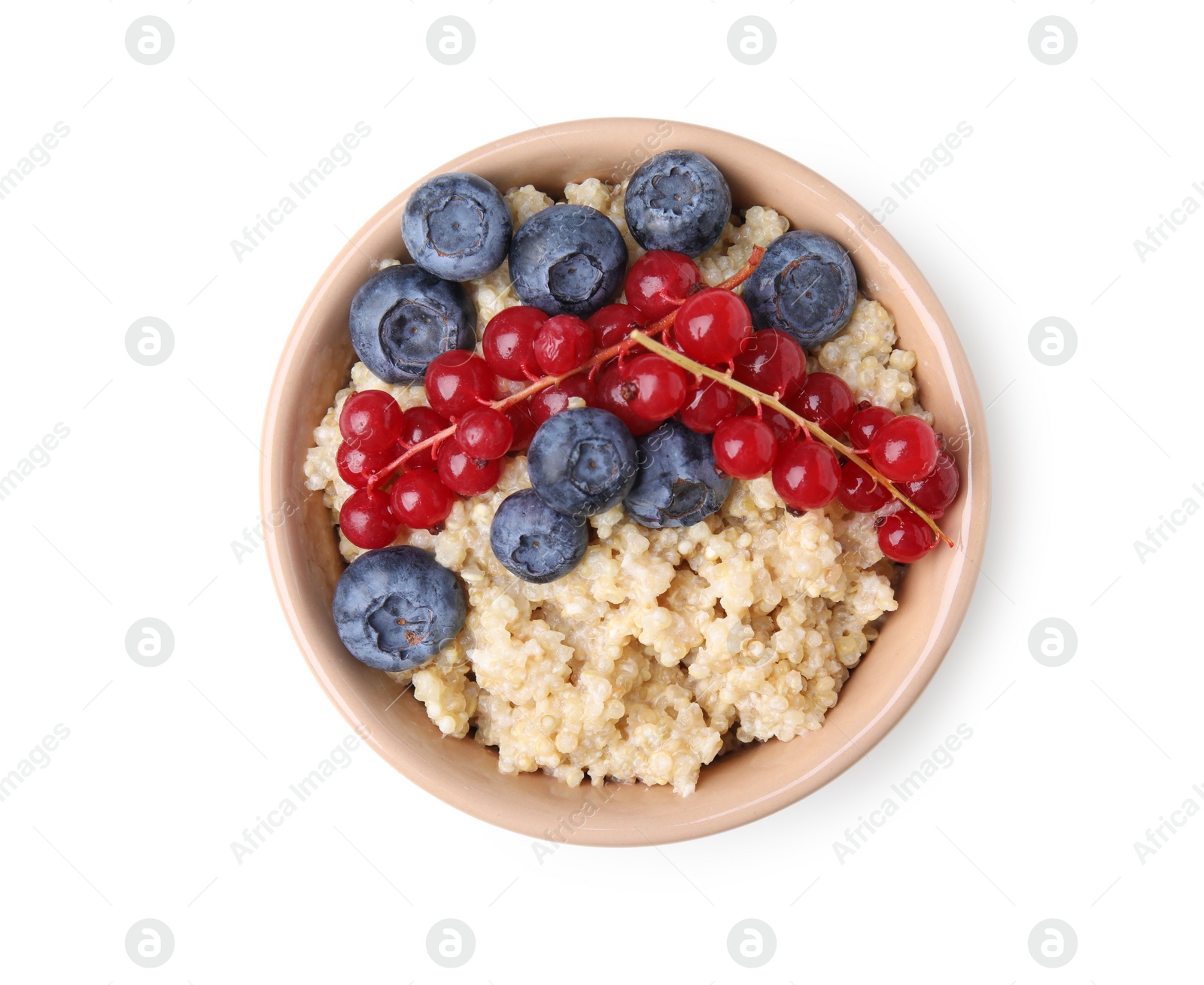 Photo of Bowl of delicious cooked quinoa with blueberries and cranberries isolated on white, top view