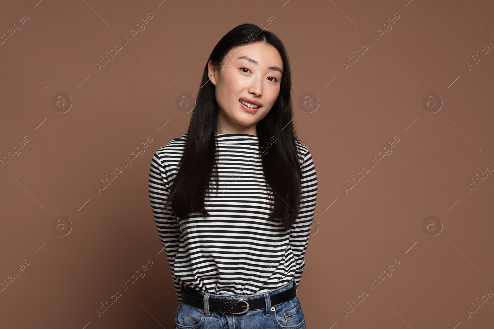 Photo of Portrait of smiling woman on brown background