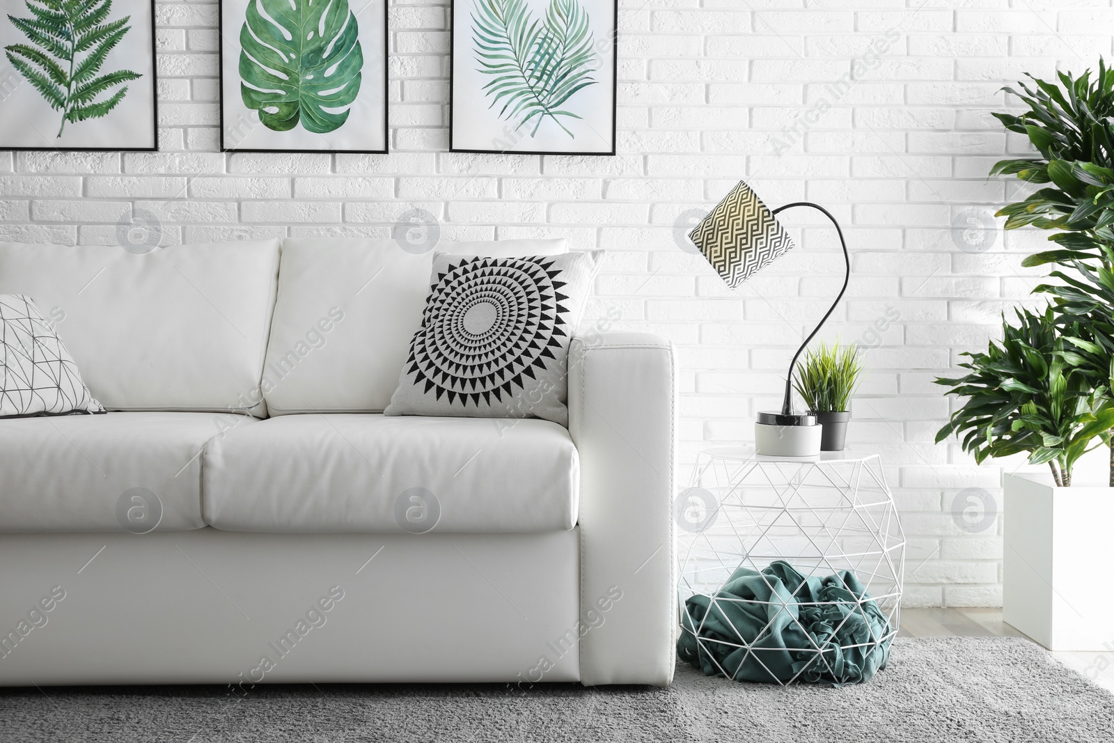 Photo of Comfortable white sofa in modern room. Interior design