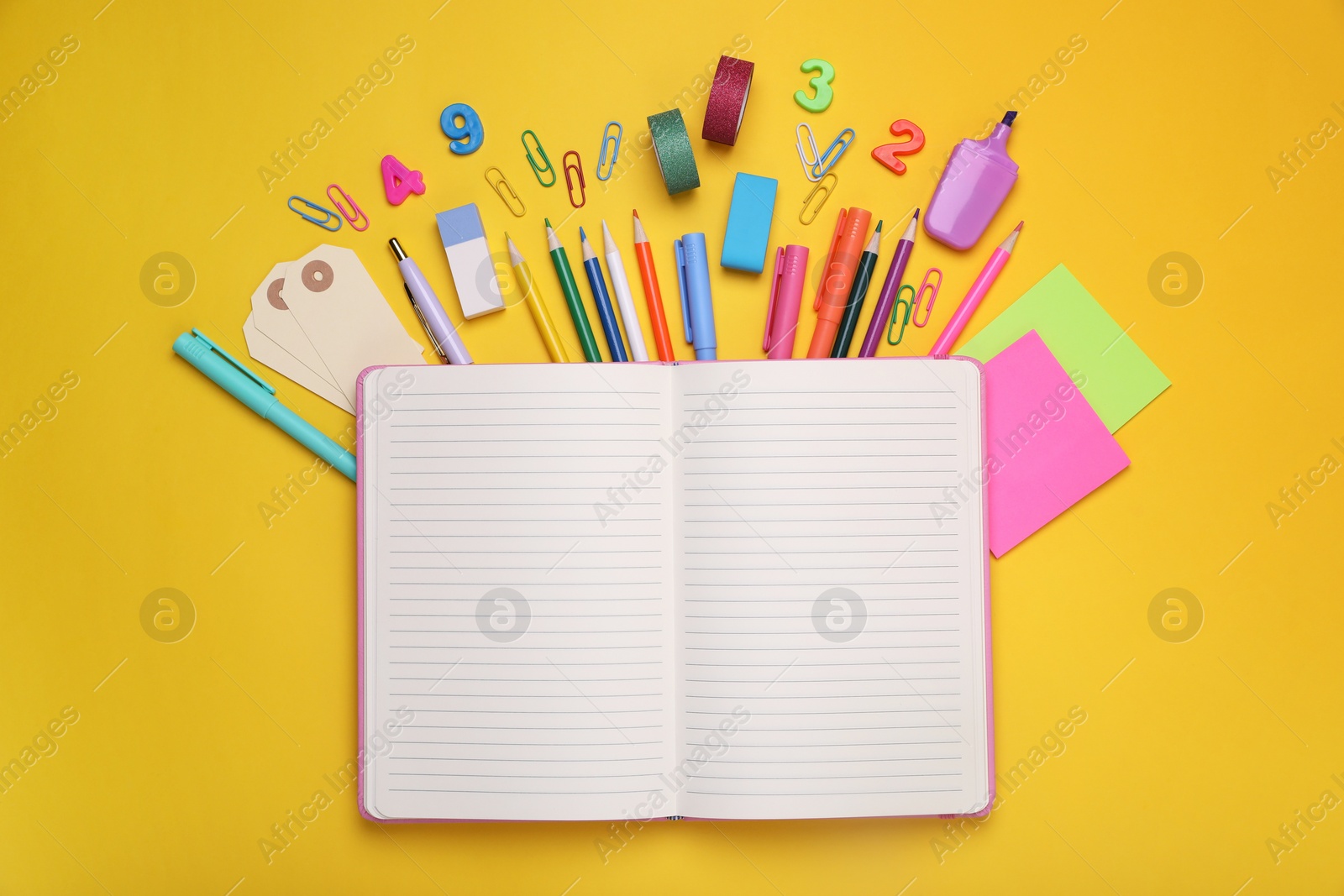 Photo of Flat lay composition with notebook and other school stationery on yellow background, space for text. Back to school