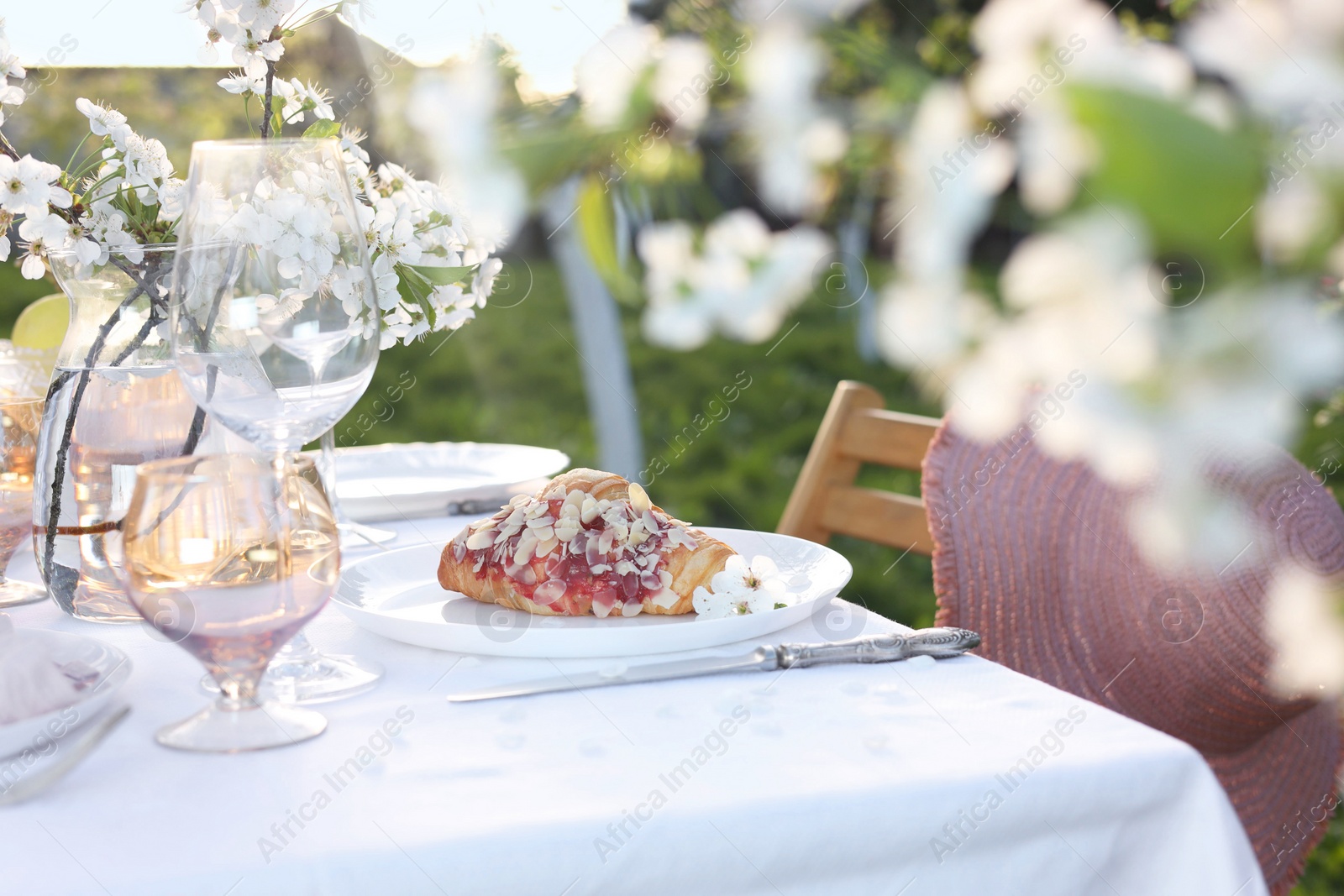 Photo of Stylish table setting with beautiful spring flowers in garden