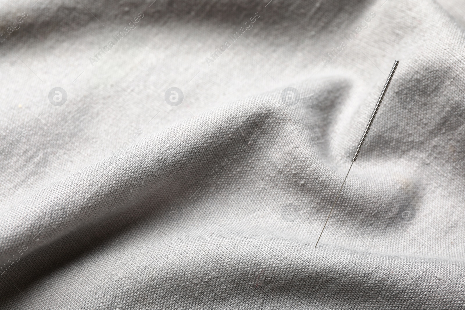 Photo of Needle for acupuncture on gray fabric