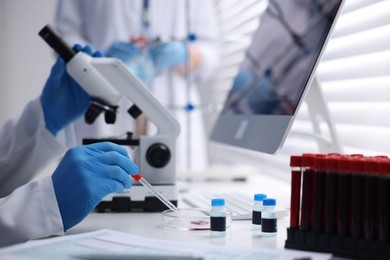 Photo of Scientists working with samples in laboratory, closeup. Medical research
