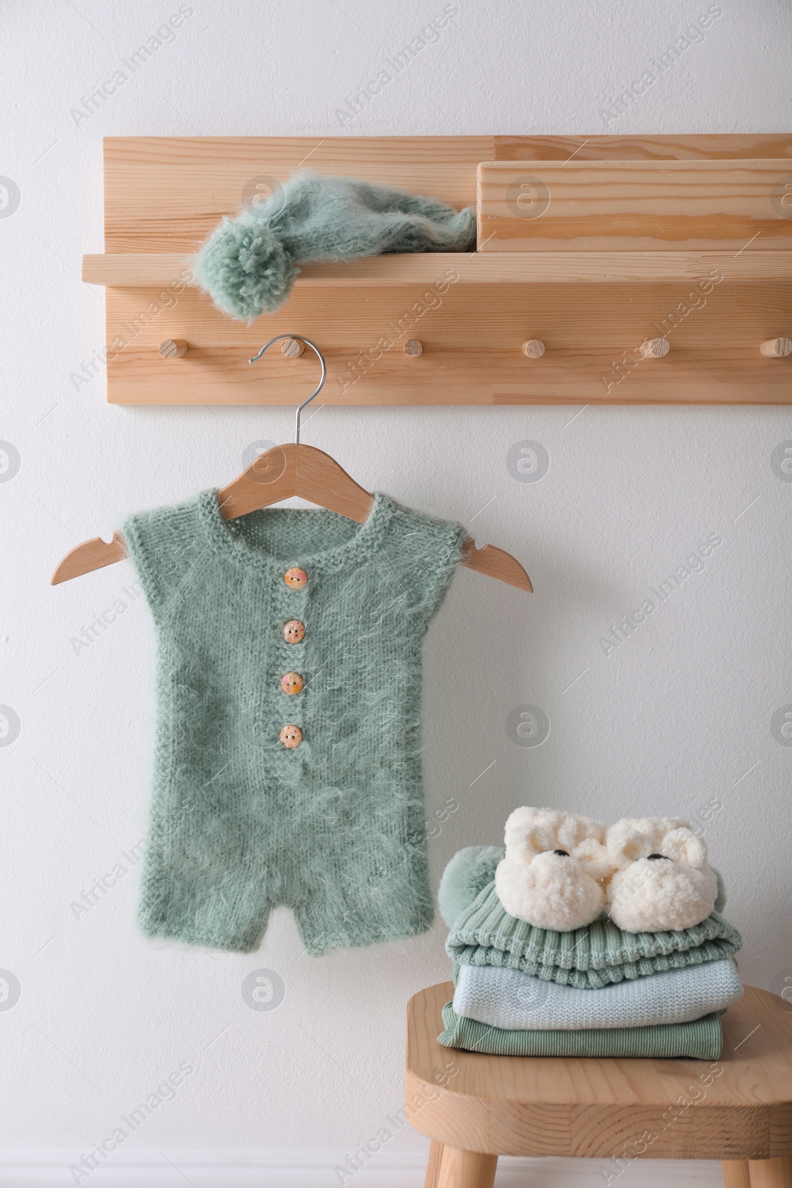 Photo of Cute children's clothes and shoes in room