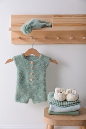 Photo of Cute children's clothes and shoes in room