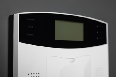 Photo of Home security alarm system on gray wall, closeup