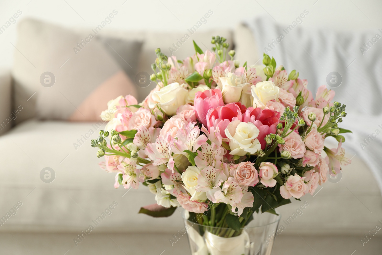 Photo of Beautiful bouquet of fresh flowers in vase indoors