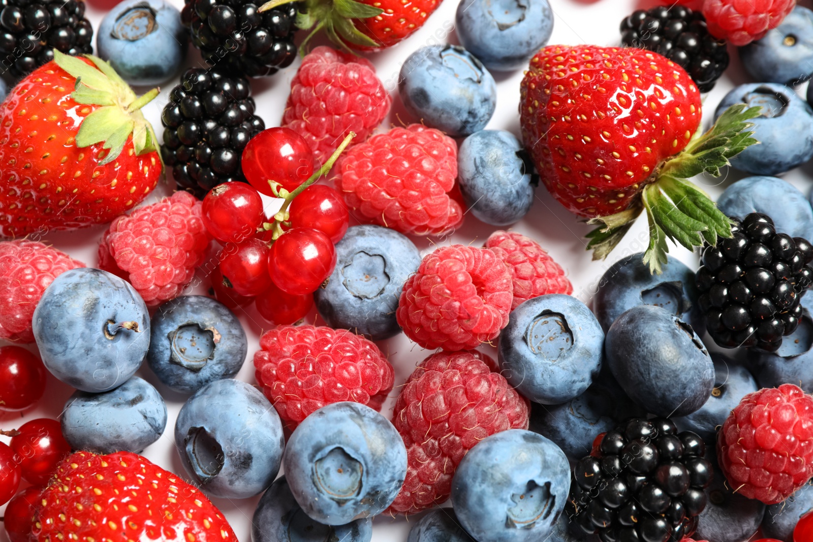 Photo of Mix of fresh delicious berries as background, top view