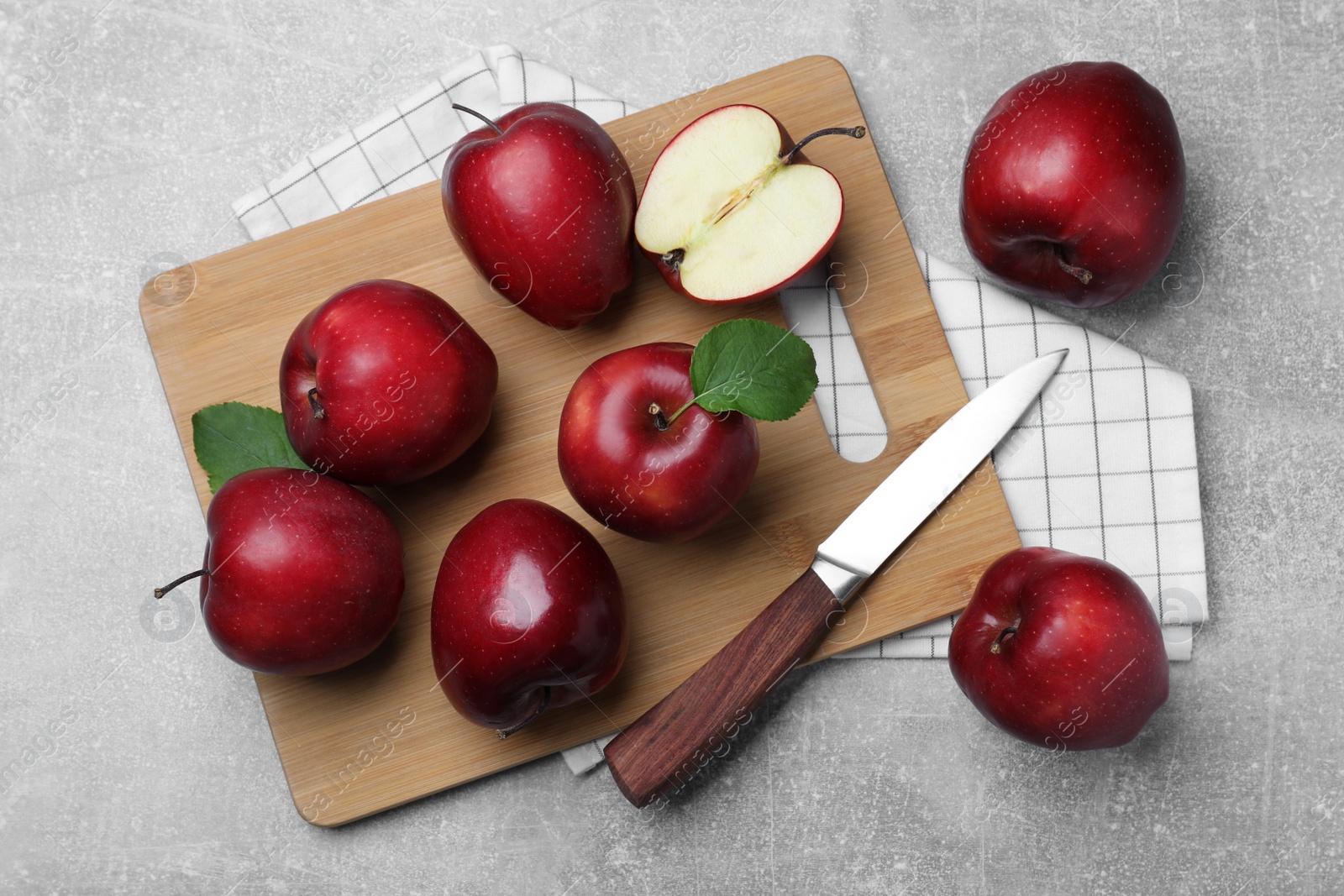 Photo of Fresh ripe red apples and knife on light grey table, flat lay