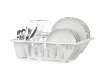 Rack with clean tableware and utensils on white background. Washing dishes