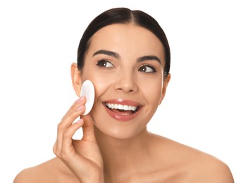 Photo of Beautiful young woman applying face powder with puff applicator on white background
