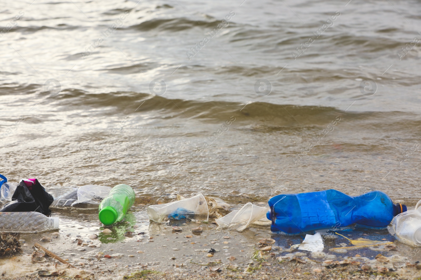 Photo of Beach polluted with plastic garbage. Ecological problem