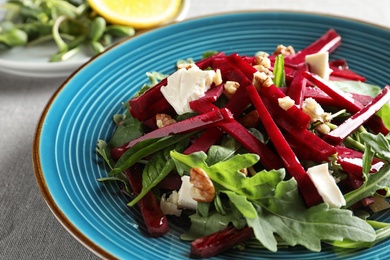 Plate with delicious beet salad on table, closeup