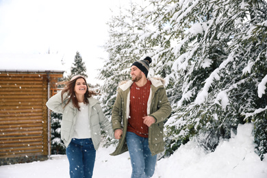 Photo of Lovely couple spending time together on snowy day. Winter vacation