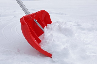 Removing snow with shovel outdoors. Winter weather